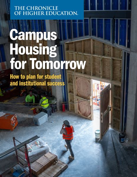 Chronicle Report: Campus Housing For Tomorrow - image of construction works inside of a building they are working on with a door open to the outside, shining daylight on the endeavor